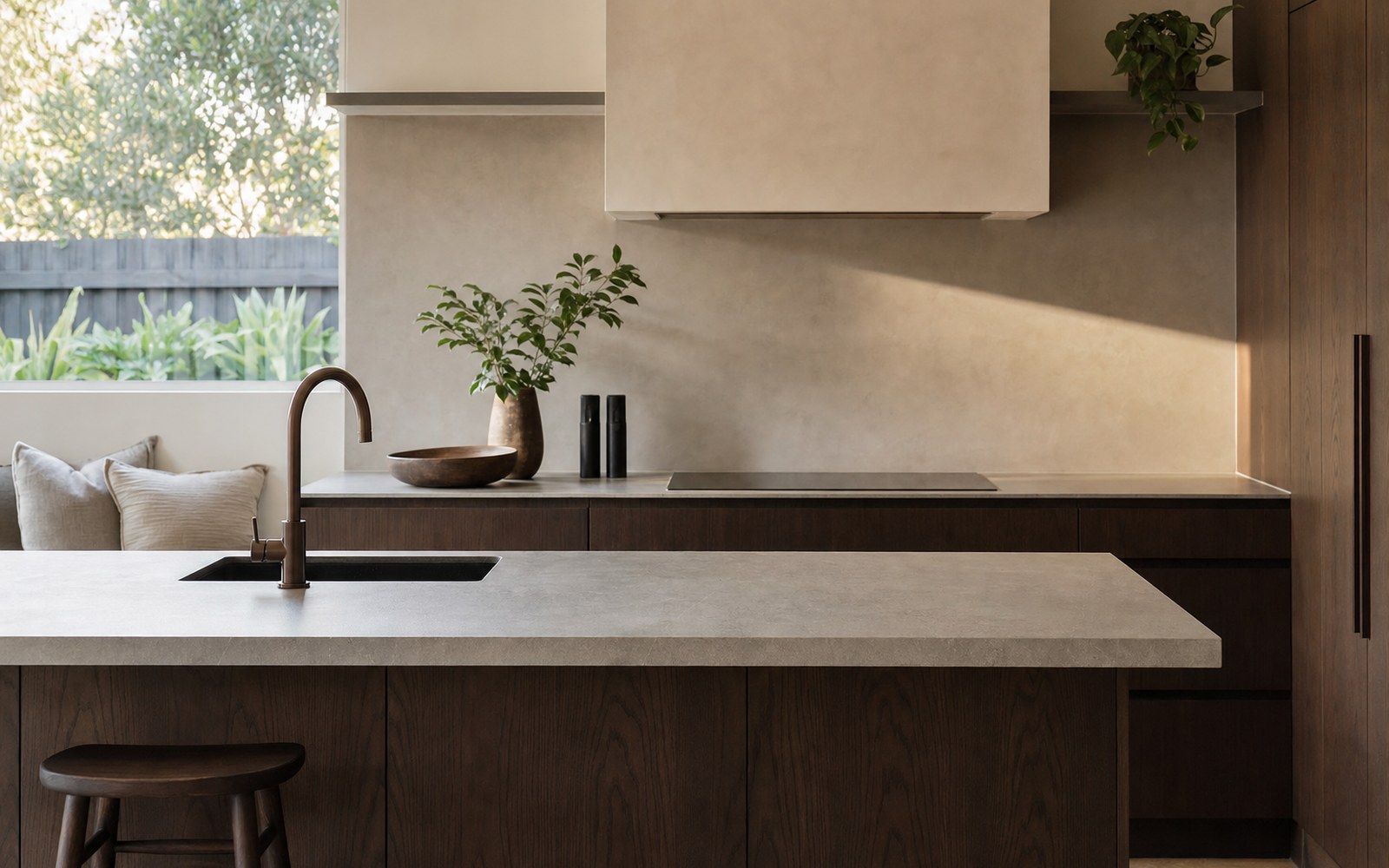 Sintered stone benchtop in a custom kitchen joinery Newcastle NSW — Dekton slab with dark timber cabinetry