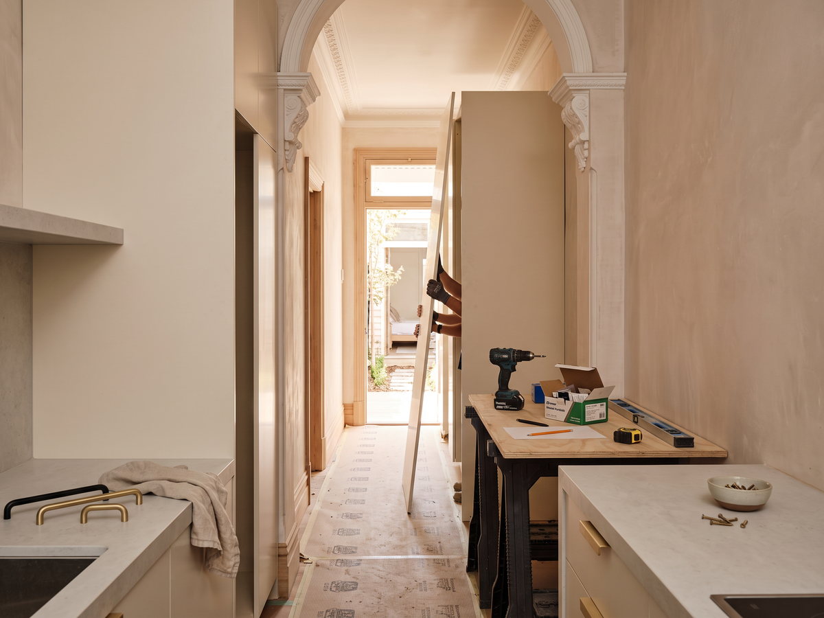 Joinery panels carried through a narrow Eastern Suburbs terrace hallway