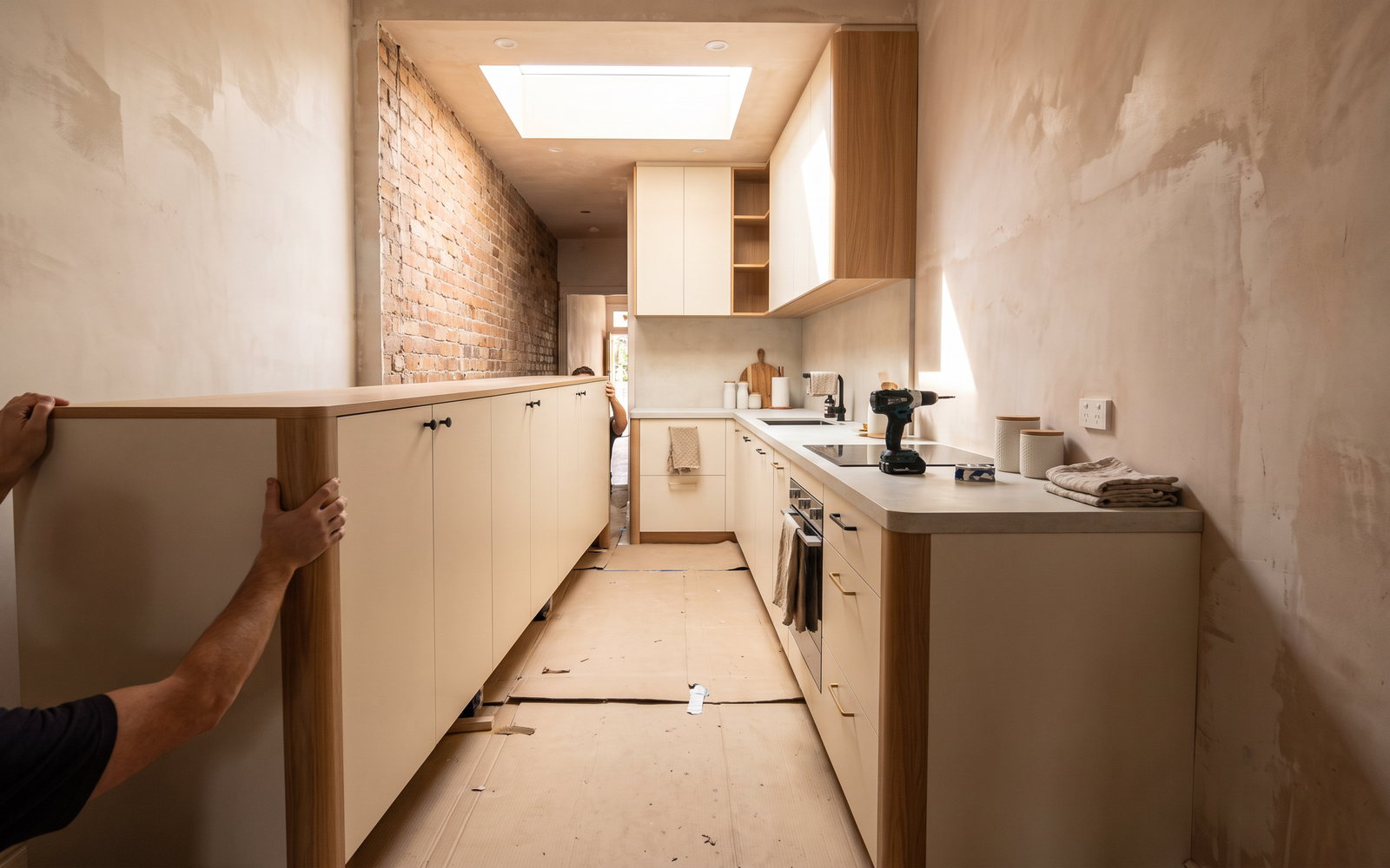 Custom galley kitchen installation carried through a narrow terrace hallway