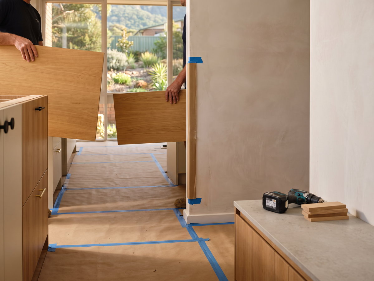 Cabinet components carried through a coastal Wollongong apartment entrance
