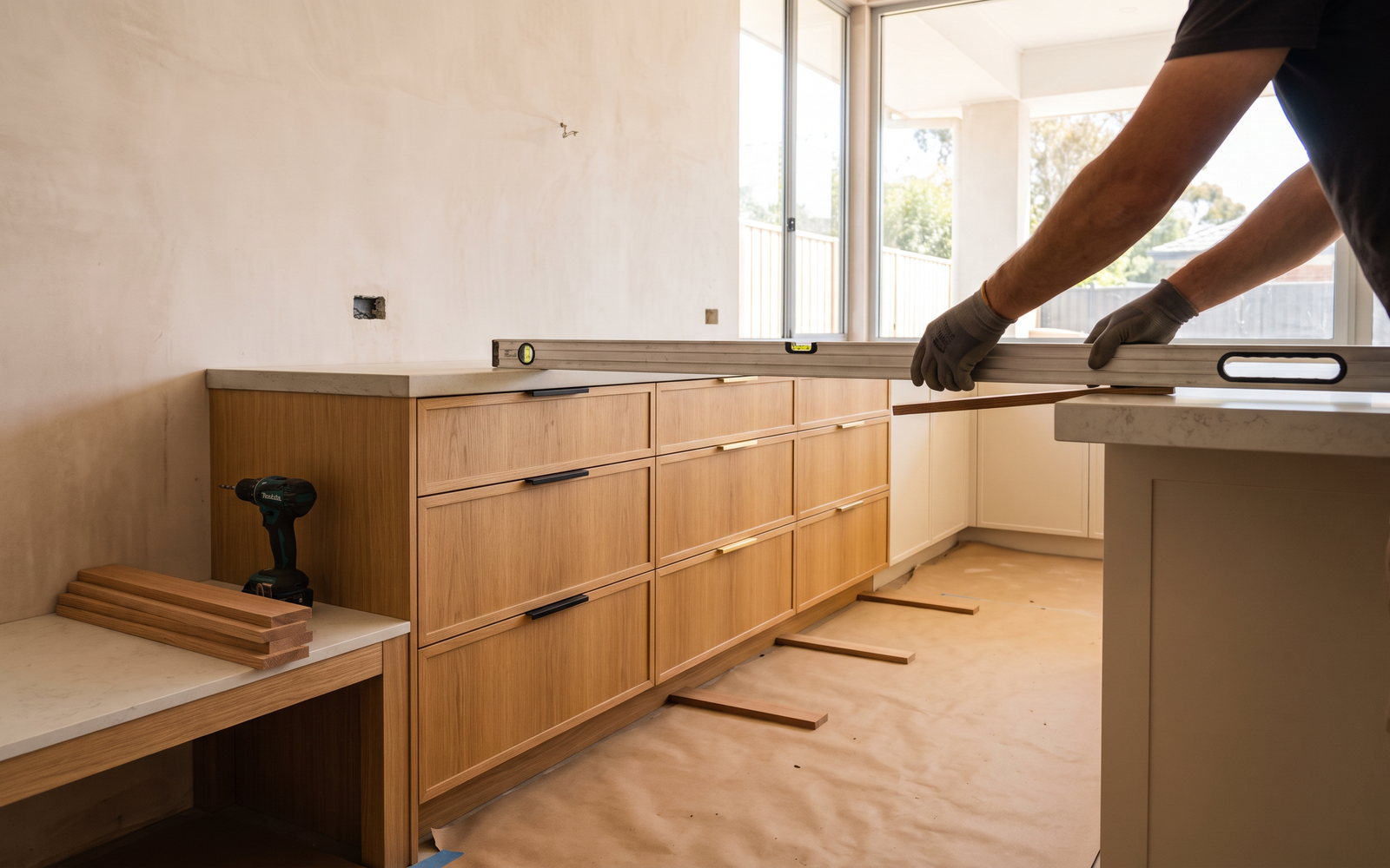 kitchen renovation timeline in New South Wales — SteepWood custom joinery Newcastle joiner installing custom kitchen cabinetry during NSW renovation programme